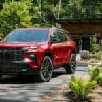 A red 2024 Chevy Traverse RS is shown from the front at an angle.
