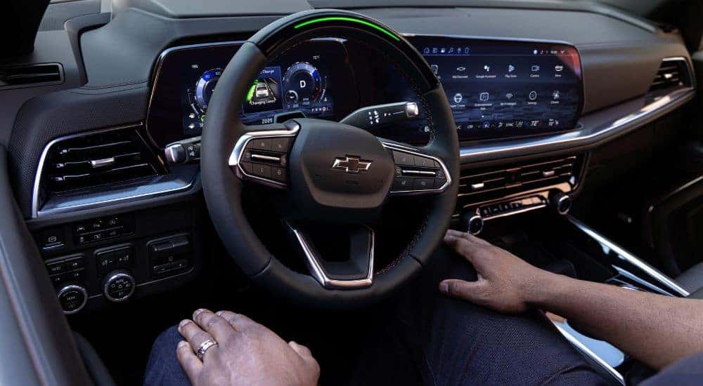 A person is shown using Super Cruise in a 2025 Chevy Suburban.