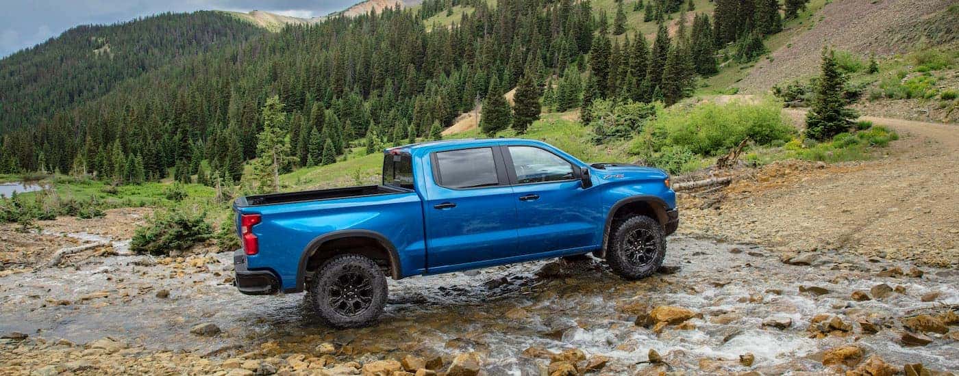 A blue 2024 Chevy Silverado 1500 ZR2 is shown from the side.