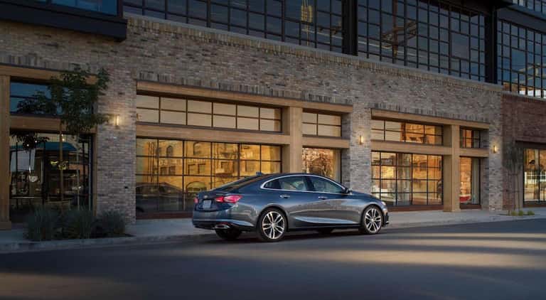 A grey 2021 Chevy Malibu is shown from the rear at an angle.
