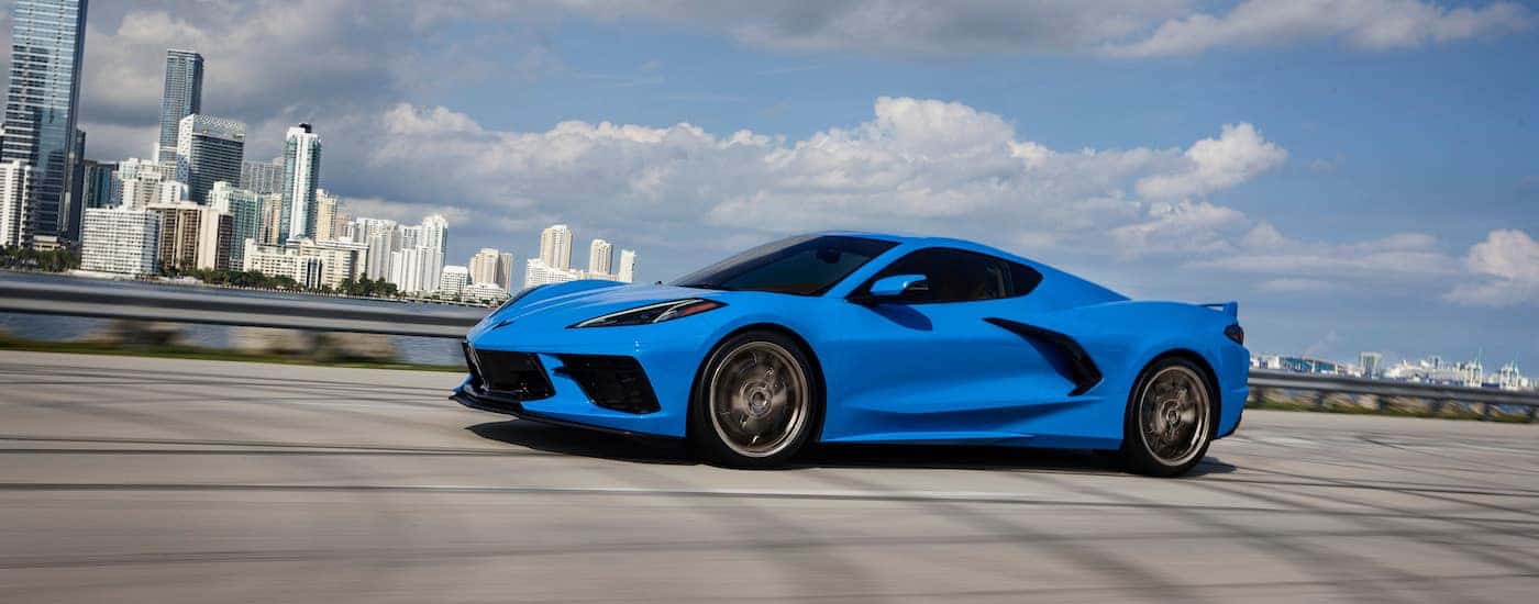 A blue 2024 Chevy Corvette Stingray is shown from the side after leaving a Chevy dealer.