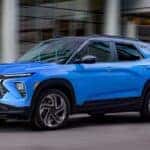 A blue 2025 Chevy Trailblazer RS is shown from the side while driving.