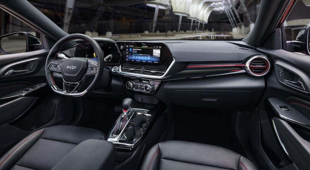The black 2025 Chevy Trax RS is shown from the passenger seat.