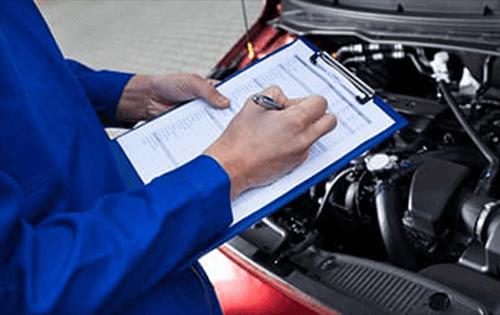 Service technician inspecting engine.