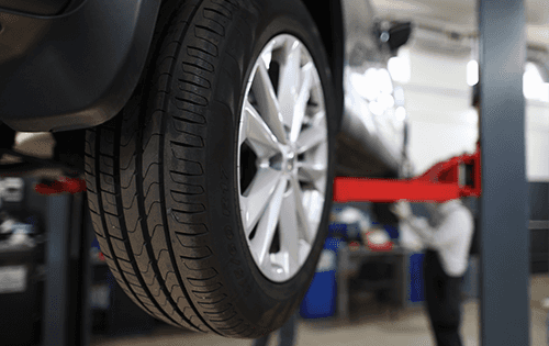 Service technician performing a tire rotation service.
