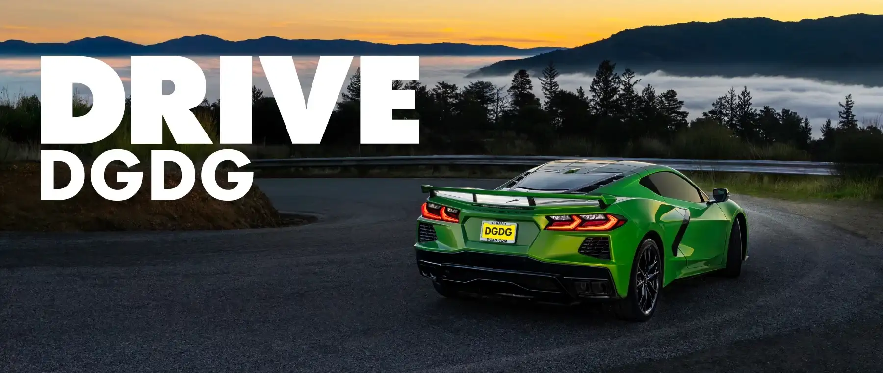 Rear angle of a bright green Chevrolet Corvette C8 sports car parked on a mountain road above a sea of clouds.
