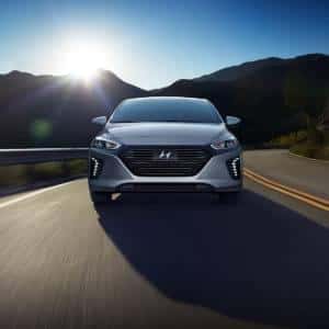 Hyundai Ioniq driving away from some mountains