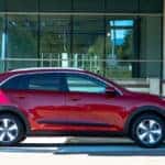 Kia Niro parked in front of a building.