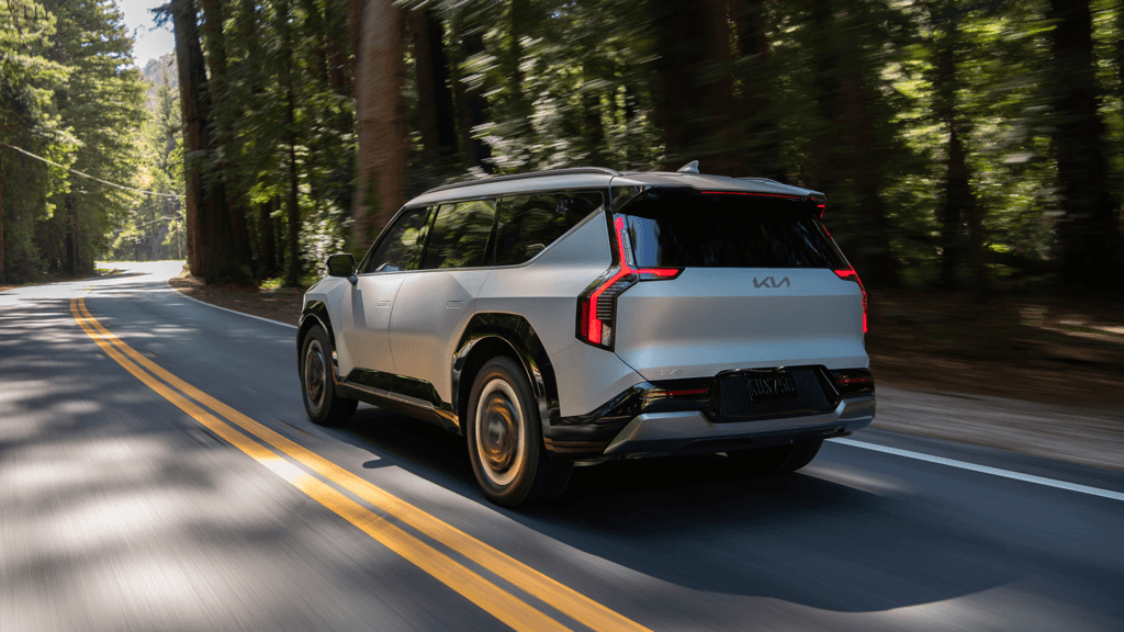 2024 Kia EV9 Driving Down a Road.