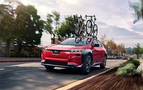 A Subaru driving down the street.