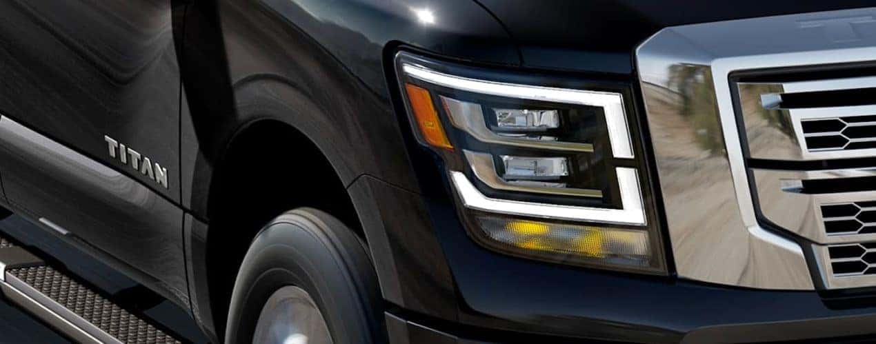 A close up shows the LED headlight on a black 2021 Nissan Titan.