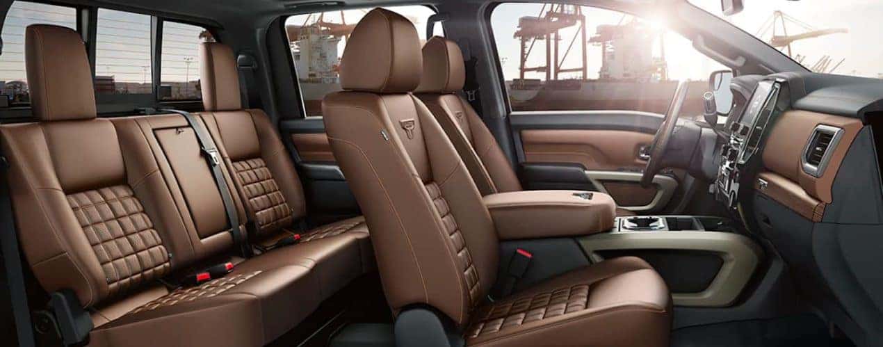 The brown interior and seating is shown from the passenger side of a 2021 Nissan Titan.