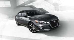 A grey 2020 Nissan Altima is shown against a faded background.