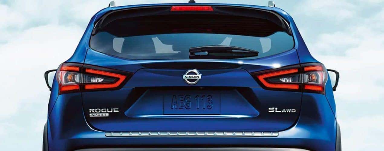 A close up shows the rear hatch and tail lights on a blue 2021 Nissan Rogue Sport SL.