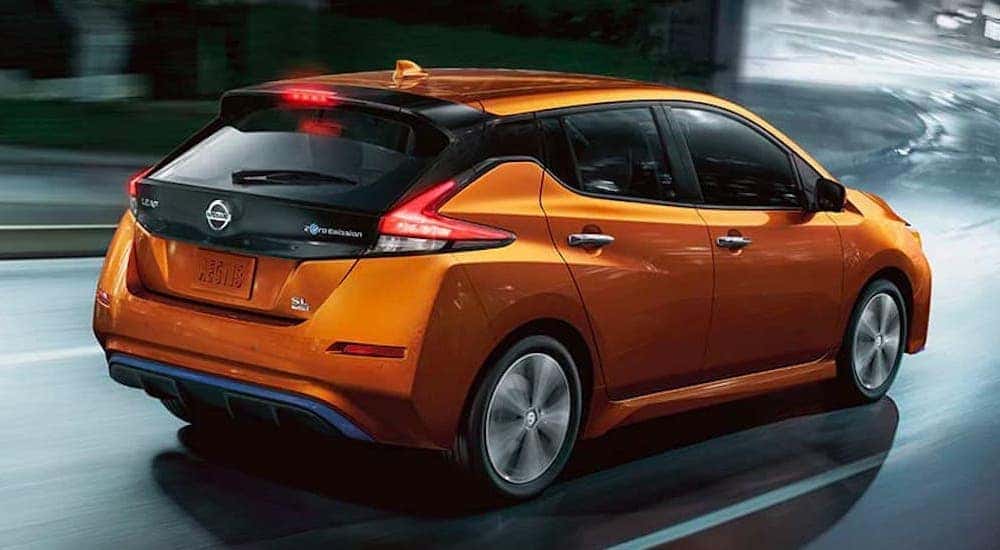 An orange 2022 Nissan LEAF is shown from the rear after visiting a Louisville electric car dealer.