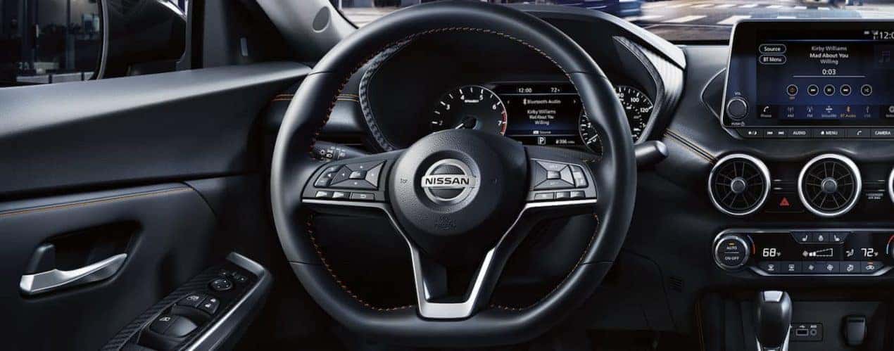 A black 2022 interior of a 2022 Nissan Sentra shows the steering wheel and infotainment screen.
