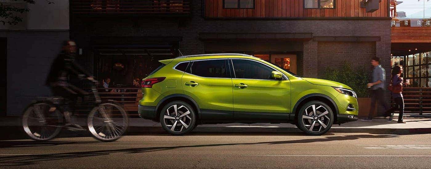 A bright green 2020 Nissan Rogue Sport is shown from the side after visiting a Certified Pre-Owned Nissan dealer.