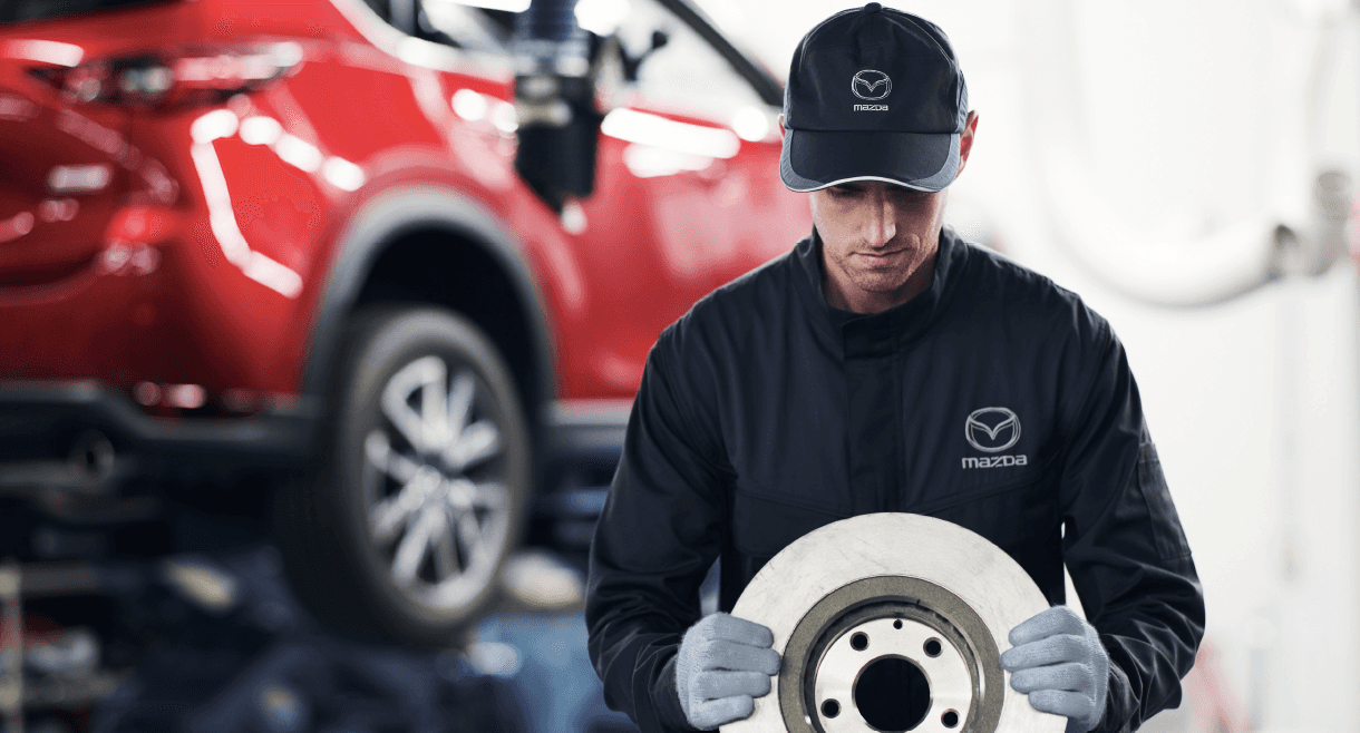 Service technician holding a replacement brake.