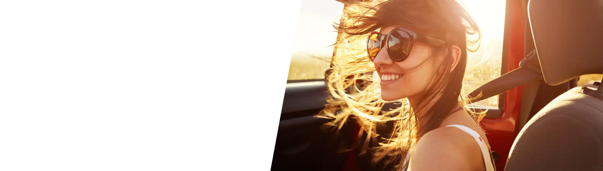 Girl riding in a car, with sunset in the background