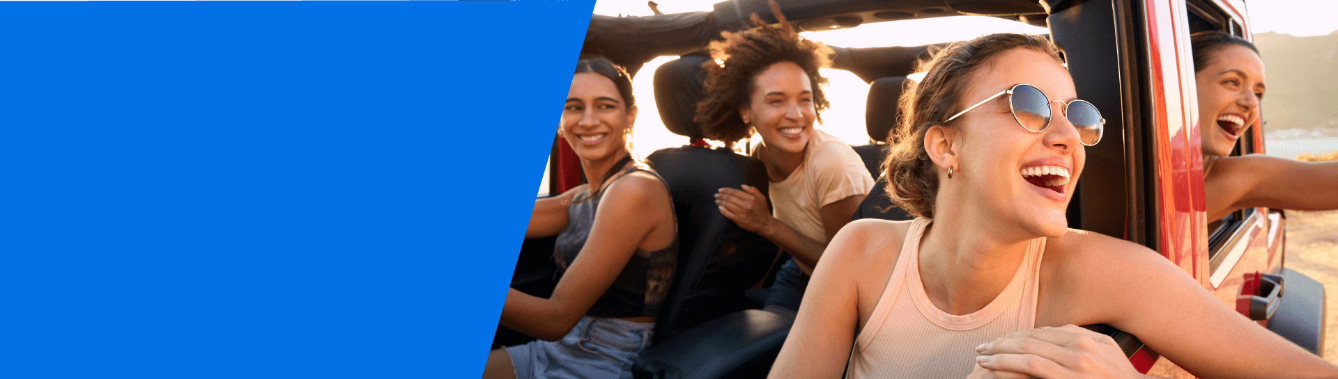 Group of 4 ladies inside a vehicle enjoying a summer drive