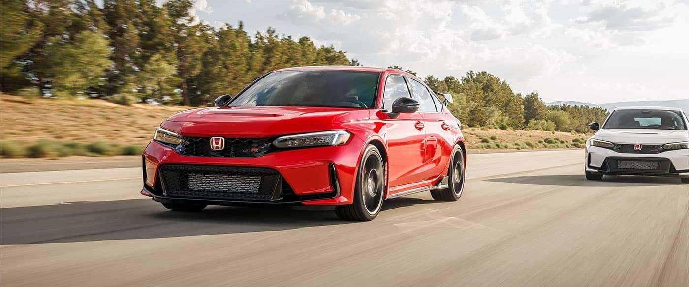 A red and a white 2023 Honda Civic Type R is shown driving on an open road.