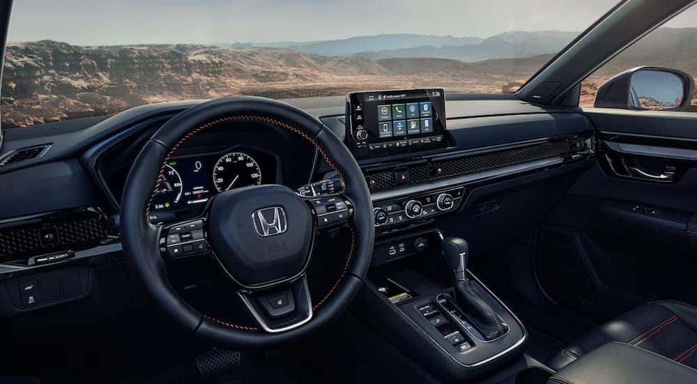 The black interior and dash of a 2023 Honda CR-V is shown.