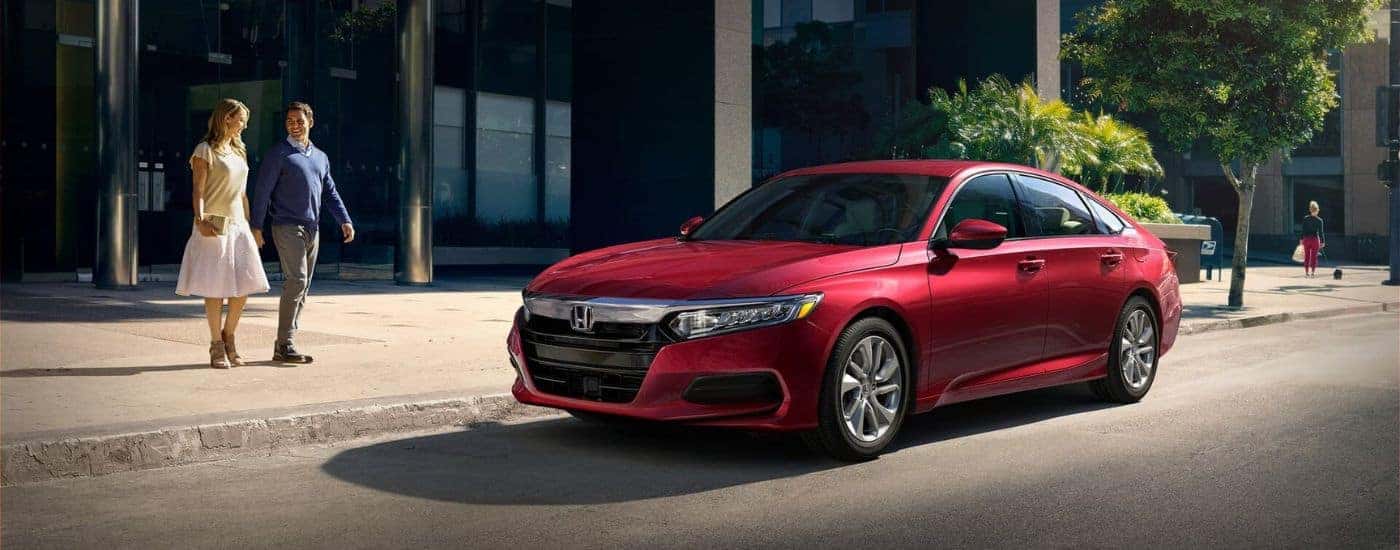 A red 2020 Honda Accord LX is shown parked on the side of a city street.