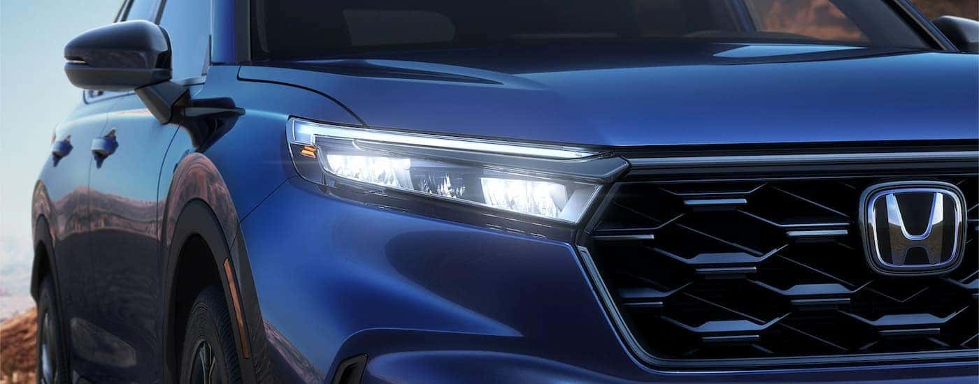 A close up of the grille on a blue 2023 Honda CR-V is shown at a Honda dealer near Tuttle, OK.