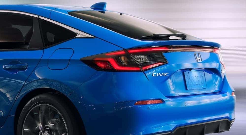 The rear-end hatch of a blue 2024 Honda Civic is shown.