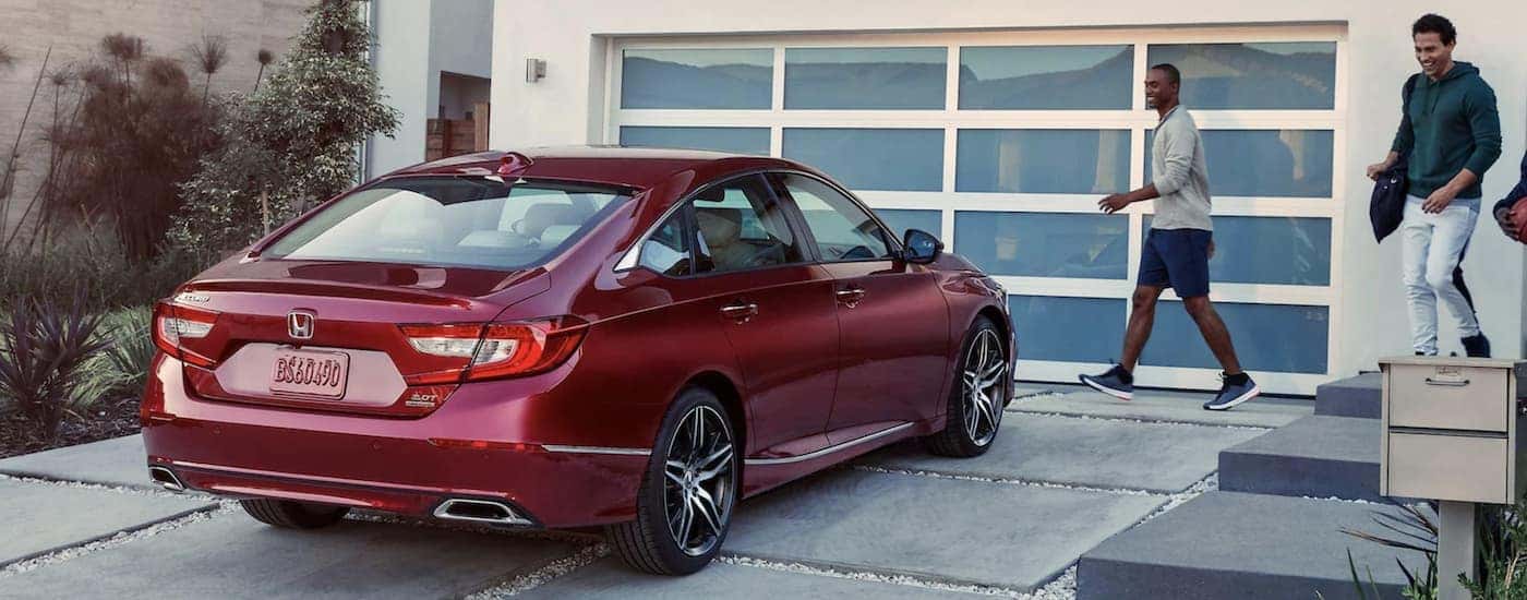 A popular Honda Accord for sale, a red 2022 Honda Accord Touring, is shown parked on a driveway.