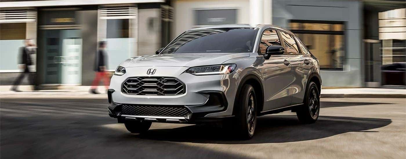 A white 2023 Honda HR-V is shown from the front at an angle after leaving a Honda dealer near Blanchard.