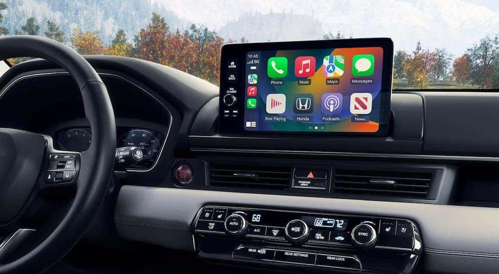 A close-up of the infotainment screen on the black dash in a 2024 Honda Pilot.