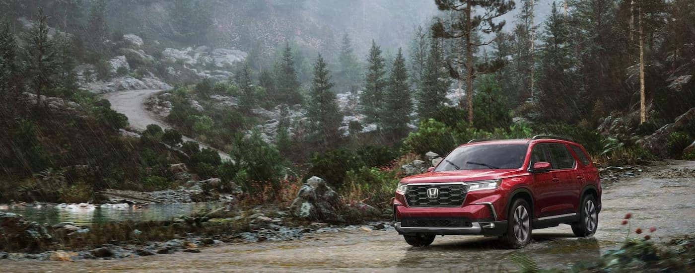 A red 2025 Honda Pilot for sale is shown from the front at an angle.