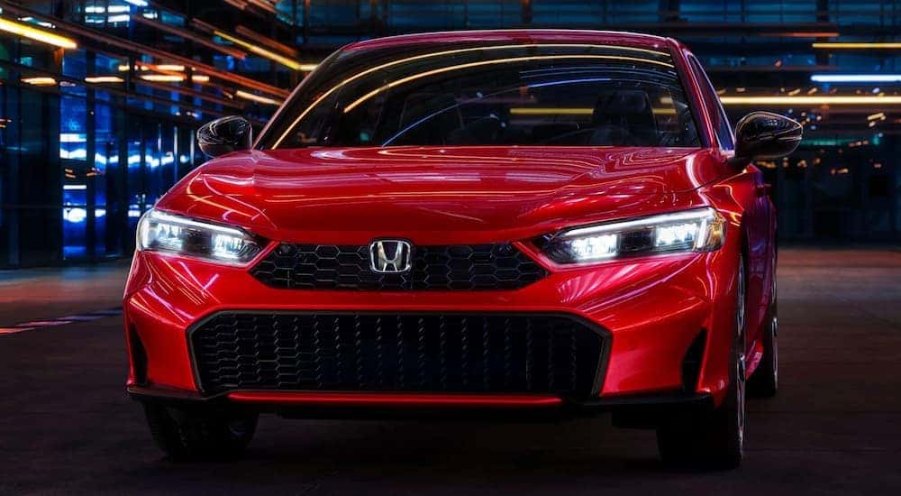 Close-up on the front of a red 2025 Honda Civic Hybrid for sale.