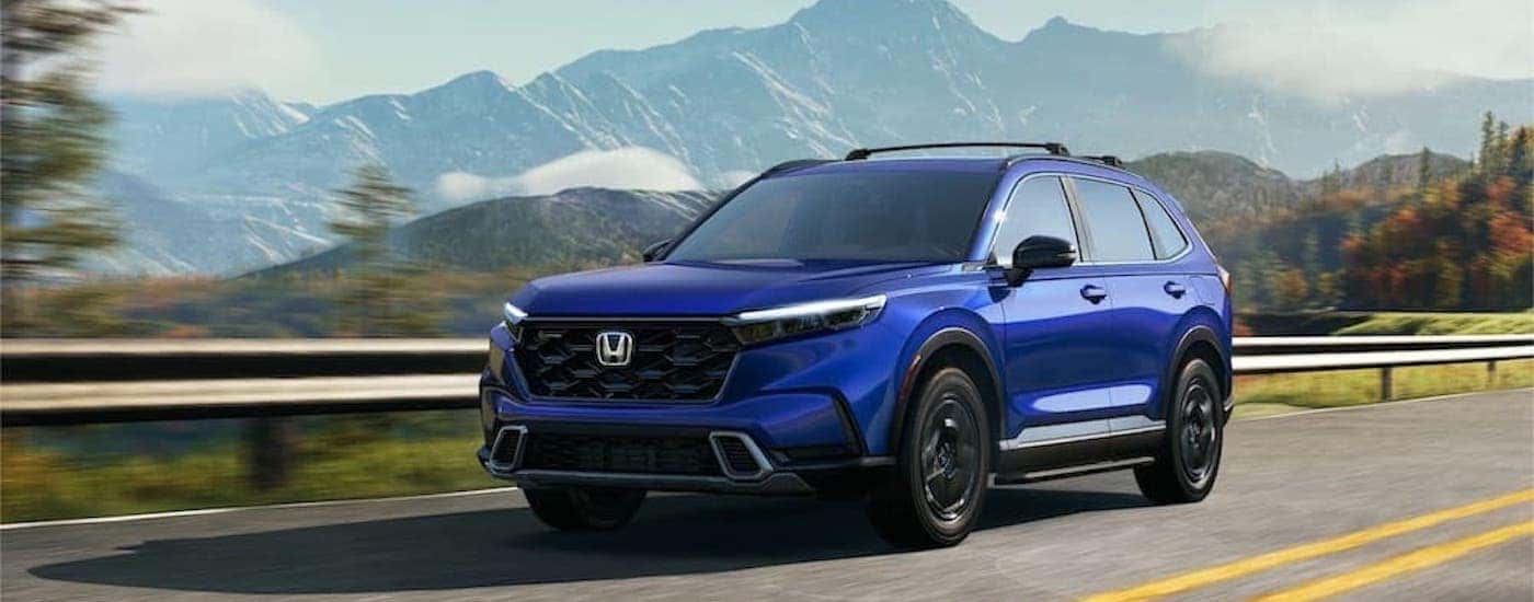 A blue 2023 Honda CR-V is shown from the front at an angle after leaving a Honda dealer near Edmond..