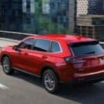 A red 2025 Honda CR-V is shown from the rear at an angle after leaving a Honda dealer near Edmond.