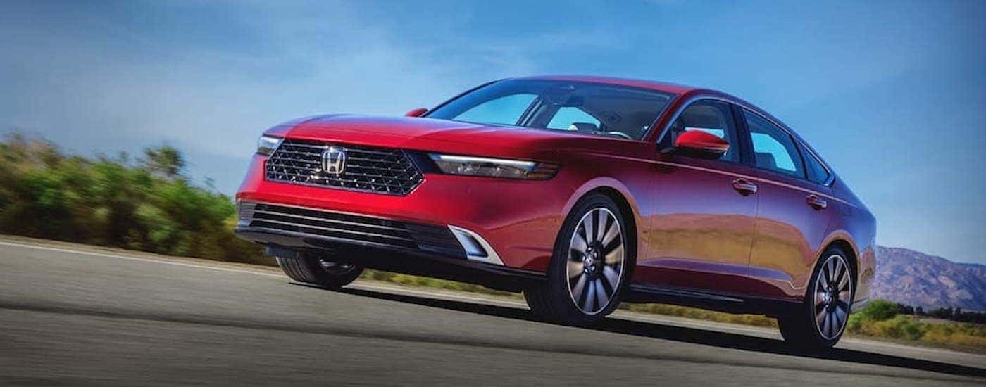 A red 2025 Honda Accord Hybrid for sale is shown from the front at an angle.