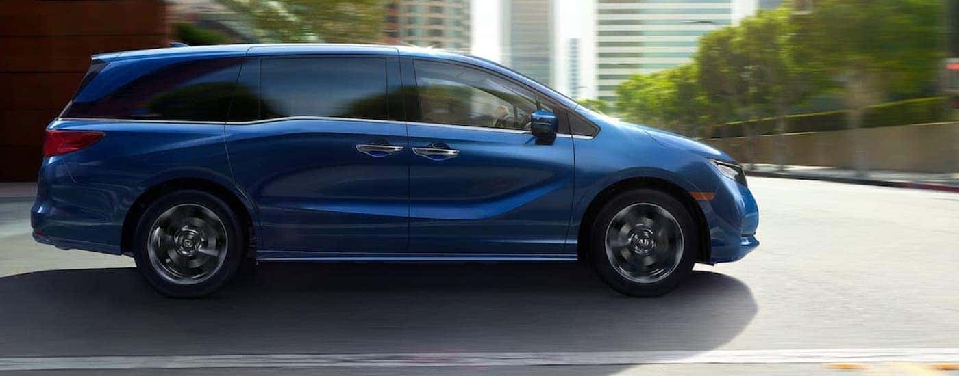 A blue 2025 Honda Odyssey for sale from the side.