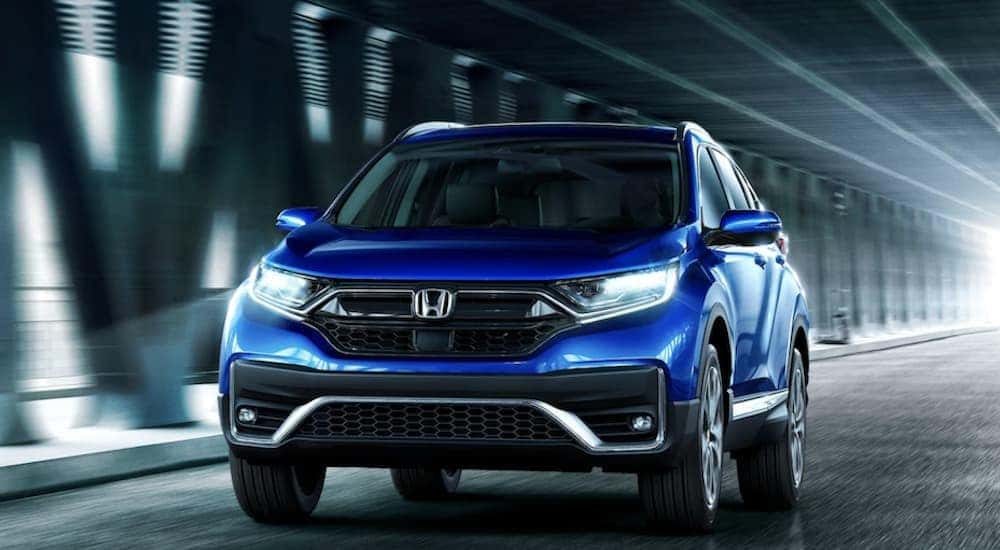 A blue 2022 Honda CR-V driving in a tunnel.