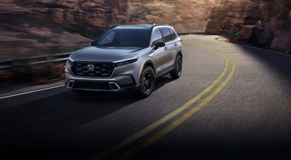 A silver 2022 Honda CR-V driving on a highway.