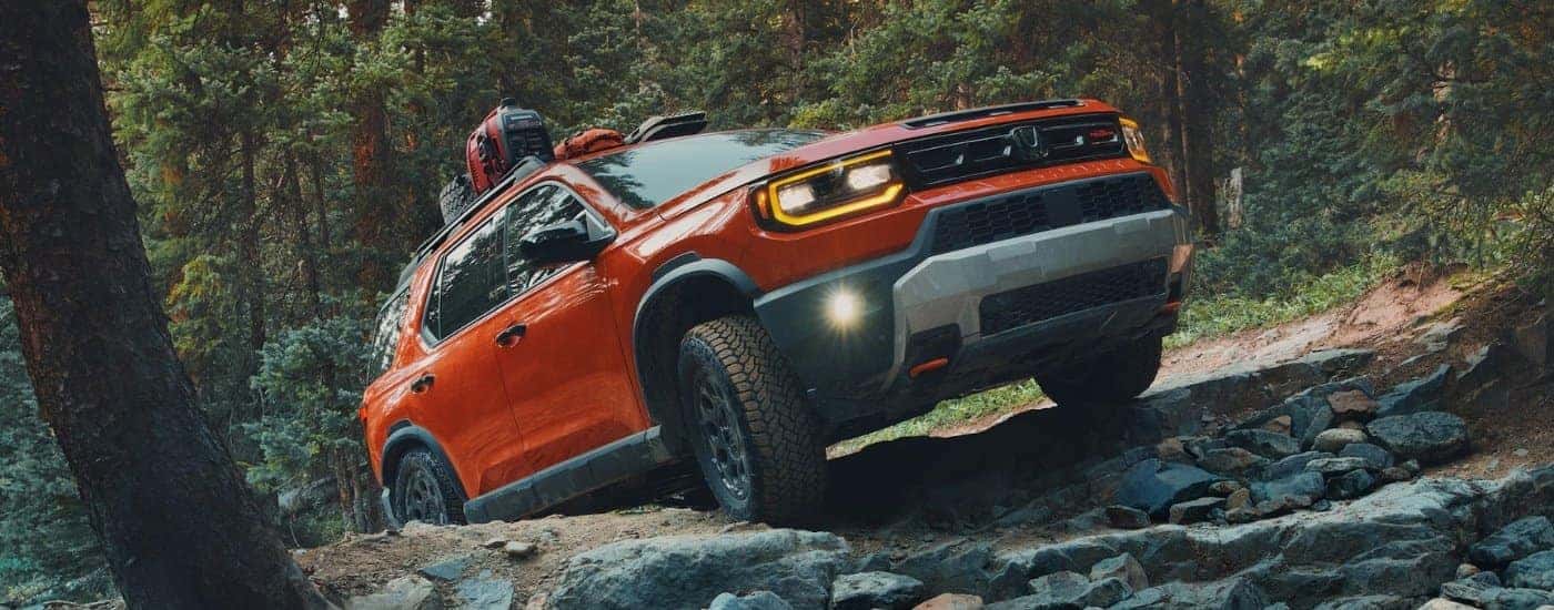 Orange 2026 Honda Passport TrailSport Elite off-roading