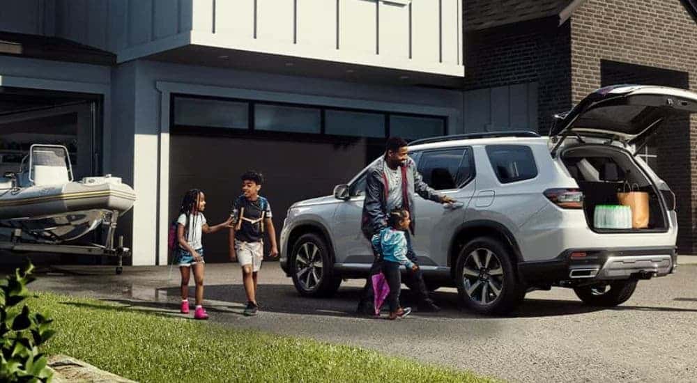 A white 2025 Honda Pilot Touring parked for sale in Oklahoma City