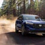 A blue 2026 Honda CR-V off-roading on a dirt road