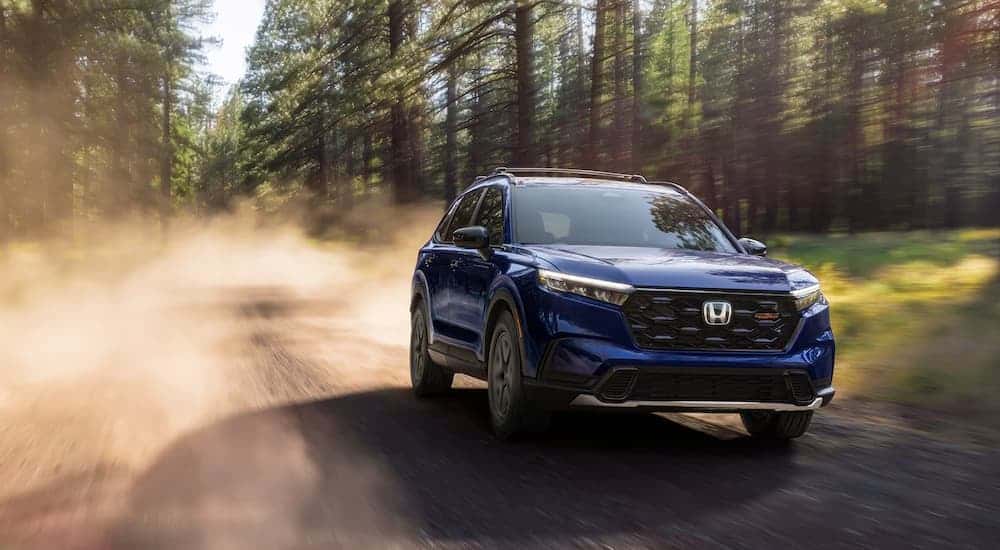 A blue 2026 Honda CR-V off-roading on a dirt road