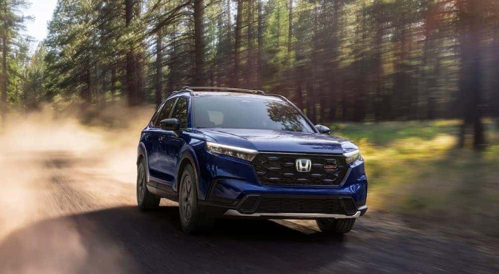 A blue 2026 Honda CR-V TrailSport Hybrid off-roading.