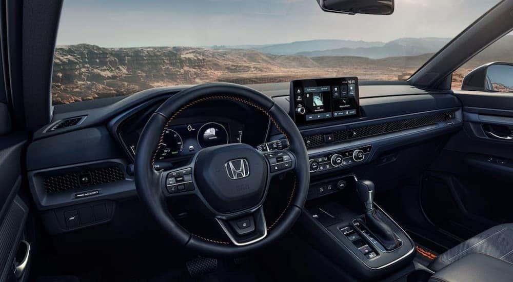 The black dash in a 2026 Honda CR-V TrailSport Hybrid near a Honda dealer near Mustang.