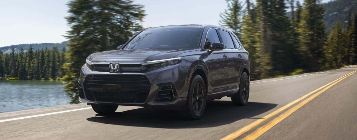 Grey 2025 Honda CR-V driving by a lake