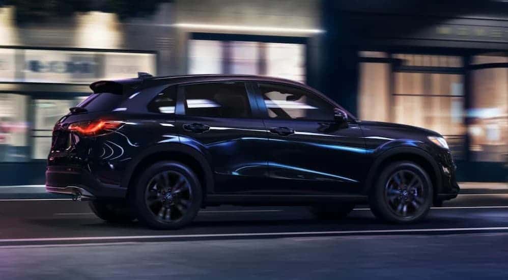 A black 2026 Honda HR-V driving at night.