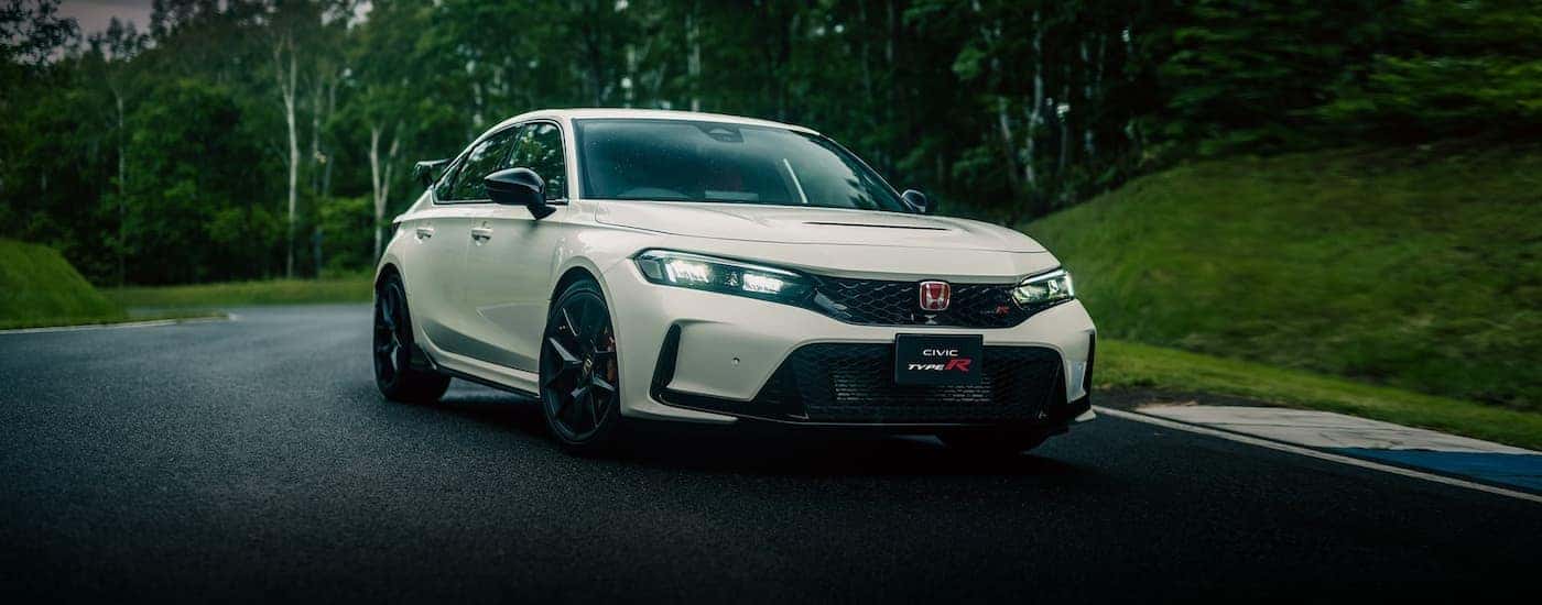A white 2023 Honda Civic Type R driving on a racetrack.
