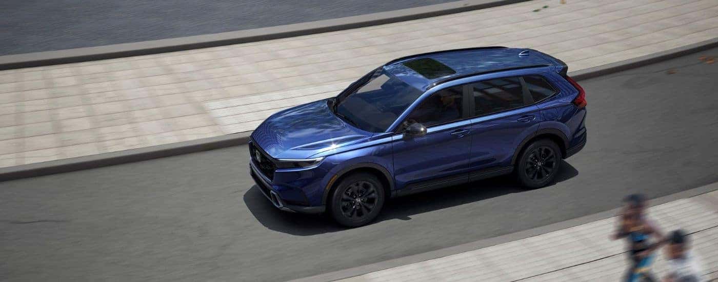 Blue 2026 Honda CR-V aerial view while driving.